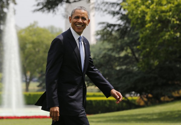 U.S. President Obama smiles as he walks away from Marine One on the South Lawn at the White House in Washington