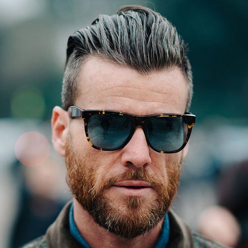 Image of Slicked back undercut oval face men haircut